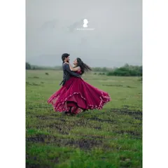 For adventurous couples, a pre-wedding shoot is a chance to create something truly epic. Here, we used the open field and dramatic sky to capture a moment of pure, carefree romance.