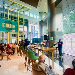 A wide view of our "Gatherings by Sheraton" event at The World Cafe, showing our capability to manage literary events in large, contemporary, and corporate spaces.