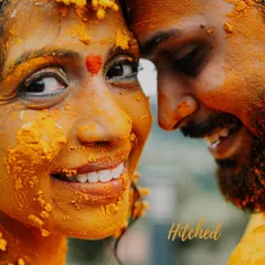A close-up of a bride's joyful face, covered in turmeric paste. Her bright smile and the word 'Hitched' tell a story of happiness and anticipation.