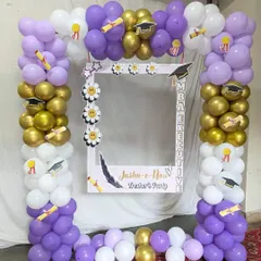 A custom photo booth frame designed for a college fresher's party. This interactive element, surrounded by a matching balloon arch, provides a dedicated spot for students to take memorable pictures.