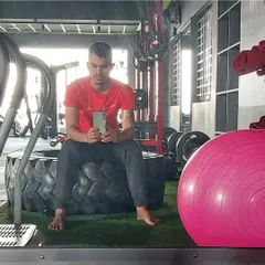 A moment of rest on a tractor tire, part of our functional and CrossFit style equipment. We use varied equipment to challenge your body in new ways.