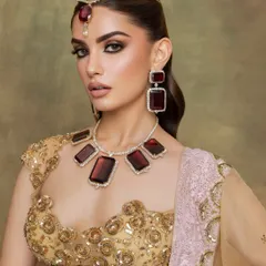 A close up of the stunning ruby and diamond jewelry, complemented by a bold, glamorous makeup look.