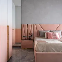 For this daughter's bedroom, we used a soft pink palette with an ombre effect on the wardrobes. The upholstered bed and headboard with geometric details add a touch of playful sophistication, creating a room that is both royal and youthful.