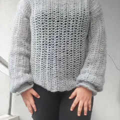A full-length view of the Vevitha Sweater, showcasing its relaxed fit and elegant drape.