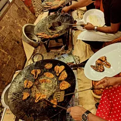 We bring the action to your event with live cooking stations. Our chefs are seen here preparing fresh Tandoori Seer Fish on a hot tawa, a favorite at weddings and sangeets.