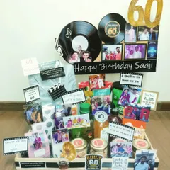 For a 60th birthday, I designed this retro-themed hamper filled with nostalgia. It features vinyl record cutouts, old photos, and treats that take them on a trip down memory lane, celebrating a life full of memories.