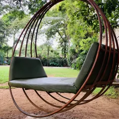 One of our comfortable swing chairs, nestled in a quiet green corner of the resort. It's an ideal spot for reading a book or simply enjoying a moment of peace.