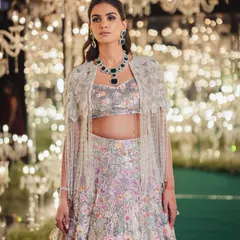 For a bride's sangeet, we wanted a showstopper. This stunning floral lehenga with a beaded cape was a look we spotted on the runway and knew it was the one. It’s all about finding that perfect balance of glamour and personality.