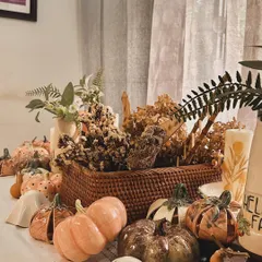 A wide shot of my autumn tablescape, complete with ceramic pumpkins, friendly ghosts, dried flowers, and candles. It's everything I love about this cozy season.
