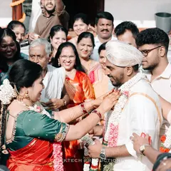 A heartwarming candid photo capturing the emotions of family members as they participate in a traditional ritual with the groom during a South Indian wedding.