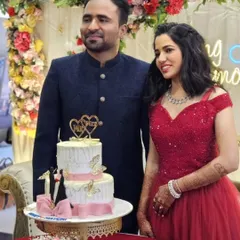 Another happy couple celebrating their ring ceremony. The bride's red gown with a sweetheart neckline is a romantic and classic choice for this special occasion.