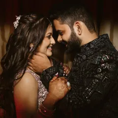 A close and intimate portrait of the couple, their smiles reflecting pure happiness. The groom's gentle hold and their shared gaze create a moment that feels both personal and timeless.