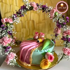 For moments that deserve something truly extraordinary, I craft custom cakes like this elegant floral creation. This piece, designed for a special celebration, features delicate fondant work and a beautiful arch of fresh flowers, showing how I can turn your dream cake into a stunning reality.