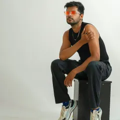 A cool, relaxed studio portrait featuring a model with colored sunglasses. This shot shows personality and is great for a commercial or lifestyle model's book.