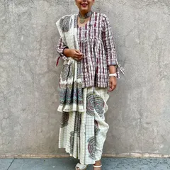 A participant in our 'Revive & Renew' workshop thoughtfully drapes her newly printed saree. It's a joy to see our guests bring their creative visions to life, blending modern styling with traditional block printing.