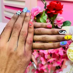 A different angle of the multi-design nail art set, showing how different fun icons like yin-yang, smiley faces, and cow print can come together for a trendy look.