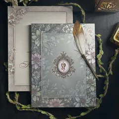 The full invitation, where the custom monogram takes center stage. The surrounding pastel floral design complements the emblem without overpowering it, creating a balanced and personal card.