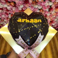 A geometric heart-shaped piñata cake. This hollow chocolate shell can be filled with candies or other treats and is meant to be smashed open for a fun surprise.