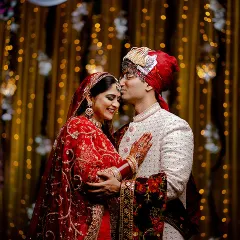 A tender forehead kiss against a glittering gold background. This portrait is the perfect blend of intimacy and glamour.