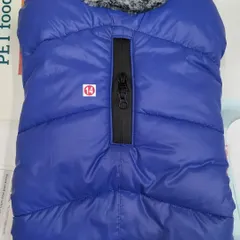 This blue puffer jacket for dogs is perfect for chilly weather. It features a convenient zipper for easy leash attachment through the back.