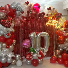This image captures the full anniversary arrangement in a home living room, showing how our designs can create a complete photo-ready backdrop for your celebration.