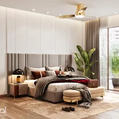 A bright and airy master bedroom with a balcony. The design features a soft, upholstered headboard, a gold-accented fan, and a comfortable seating bench, creating a functional and elegant space.