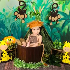 Dressed as a little lion, this baby boy looks adorable and ready for a jungle adventure in his themed photoshoot.