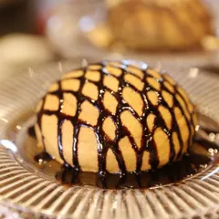 A single, perfect chocolate lava cake, with a molten center waiting to erupt. This classic dessert is always a showstopper.