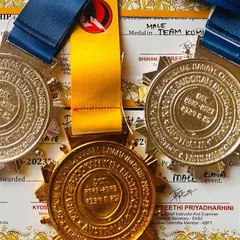 A close-up of my medals from the 2022 National Championship: Gold in weapon kata, Silver in individual kata, and Silver in team kumite. Each one is a reminder of the dedication and hard work.