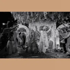 A spectacular black and white shot of the couple's celebration, surrounded by family and a shower of confetti.