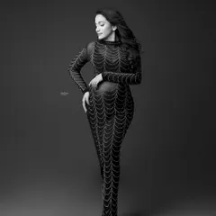 This B&W conversion of the spiderweb gown highlights the intricate pattern and the model's elegant pose. You'll learn how to edit for texture and contrast.