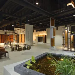 This showroom for a wood products company brings the outdoors in with a central water feature and natural materials. The space is designed as an open gallery, allowing customers to explore the products in a relaxed, biophilic environment.