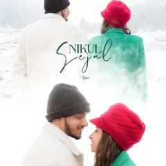 A creative and artistic portrait of Nikul and Sejal in the snow. The contrast between their colorful beanies and the white landscape, combined with their close gaze, makes for a striking and memorable image.