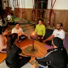Our students sit in a circle for Tratak meditation, a practice of intense focus on a candle flame. This beautiful and ancient technique is known to improve memory, willpower, and concentration.