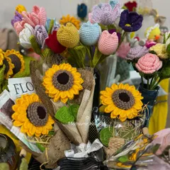 A beautiful display of our crochet flower bouquets, featuring sunflowers and tulips. These are perfect for gifting and brightening up any space.