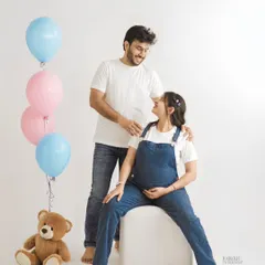 Having a bit of fun with a gender reveal theme. We use simple props like pink and blue balloons and a teddy bear to add a playful touch to your couple's shoot.