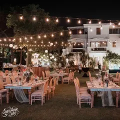 For a 50th anniversary, the theme was 'Vintage Romance'. I used strings of warm Edison bulbs to create a magical canopy over the entire garden, setting a dreamy and celebratory mood for the evening's dinner and festivities.