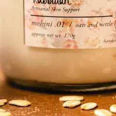A close-up of my 'Mohini' oats and nettle body yogurt with its key ingredient. Oats are incredibly soothing for the skin, and I use them to create this deeply hydrating, vegan formula.