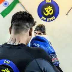 The confidence we create is visible in her eyes. This photo captures the intensity and focus of a student during a self-defense drill, ready to react and defend herself effectively.