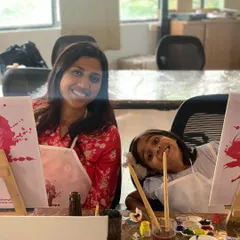 A mother and daughter painting side-by-side. Our workshops are a great opportunity for family bonding and creating colorful memories together.