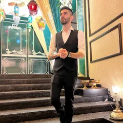 Dressed in a formal vest and shirt for a wedding reception. I understand that presentation is key, and I always coordinate with clients to ensure my look complements the event's dress code and theme.