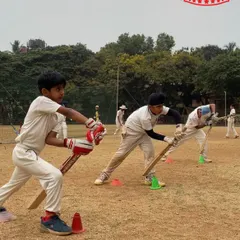 Young players practicing their batting stance on the first day of summer camp. The energy and enthusiasm are contagious.