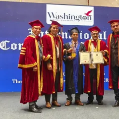 A group photograph from the International Conferment Award Ceremony. Our founder stands with other esteemed recipients and university faculty, marking a significant moment of international recognition for his work.