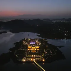 A dusk aerial view of the magnificent Raffles Udaipur, a modern palace hotel situated on its own private island. This shot was taken with my DJI Mavic 3 to capture the warm lighting, intricate design, and serene lake setting, perfect for a luxury hotel promo video.
