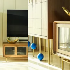 I love playing with creative angles and compositions. This artistic shot focuses on the unique design of the furniture, contrasting the clean lines of the wooden media console with the bold, spherical legs of the cabinet. It’s an example of how I find interesting details to make my interior photography stand out.