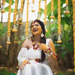 The Haldi ceremony is all about joy, and the decor should match. Here, the bride is radiant amidst a backdrop of hanging marigolds and a traditional setup, creating a picture-perfect moment of happiness.
