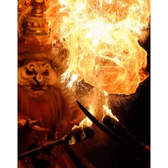 A breathtaking moment as a performer breathes fire. Capturing such a fast and dangerous moment requires precise timing and technical skill in low light.
