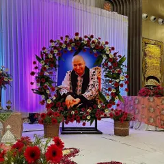 A close up of the floral wreath we created around Guru Ji's portrait. Using fresh red and white flowers, this arrangement becomes a beautiful focal point for the event's main stage.