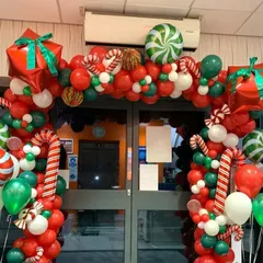 I create bold and festive entrances to welcome customers during the holidays. This Christmas balloon arch is packed with red, green, and white balloons, candy canes, and gift box accents.