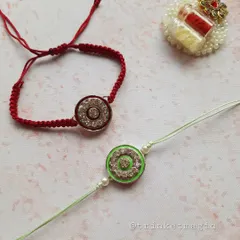 A pair of my sparkling crystal Rakhis in red and green. These are a great option if you want something that feels traditional but has a modern, festive shine.